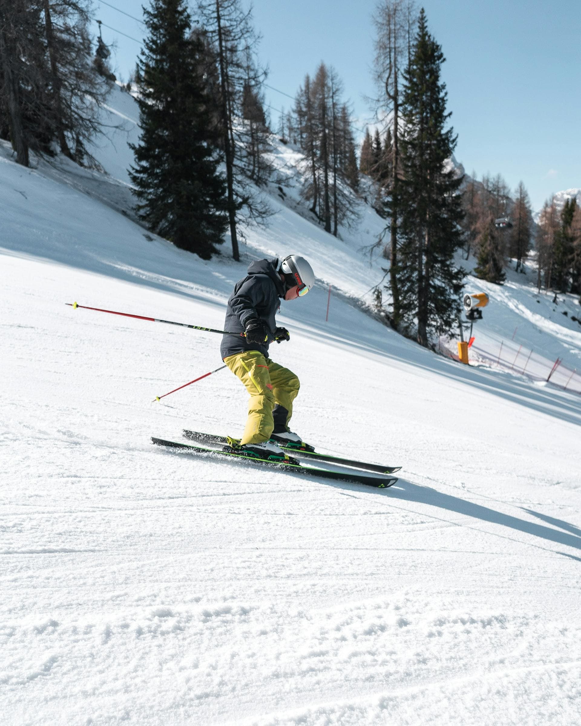 Skier carving down a sunlit Borovets piste