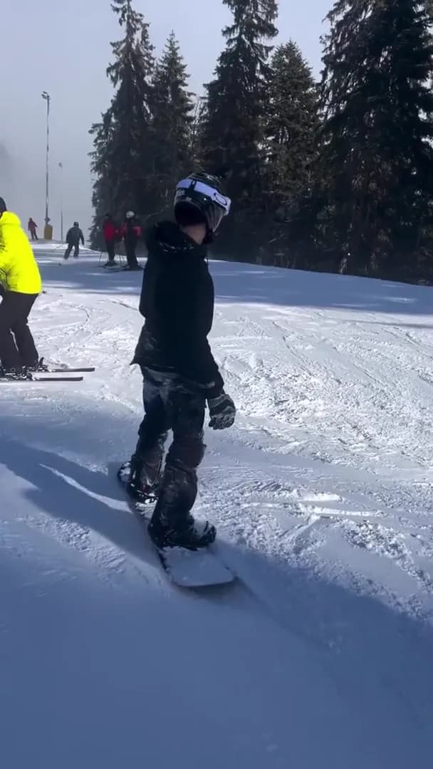 Snowboarder making his way through a crowd of skiers and snowboarders