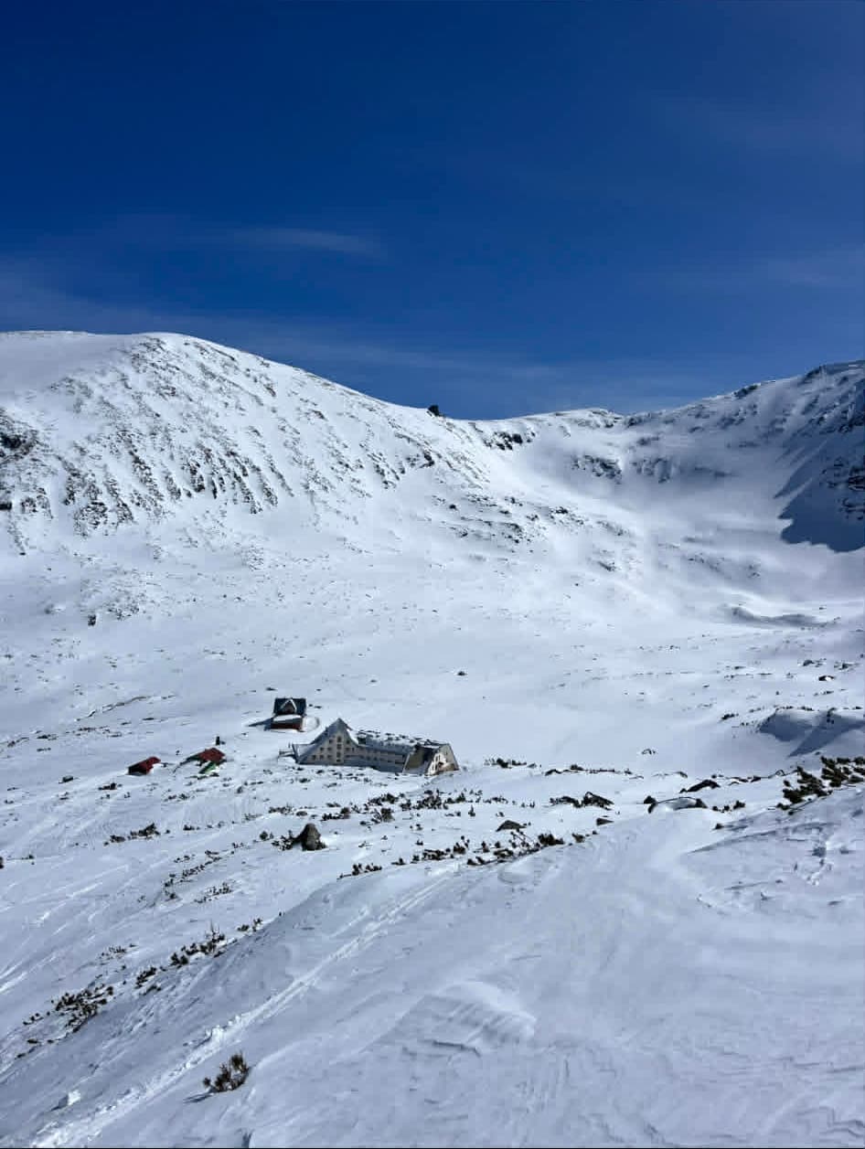 Wide cinematic view of the Rila hut and the mountain peaks
