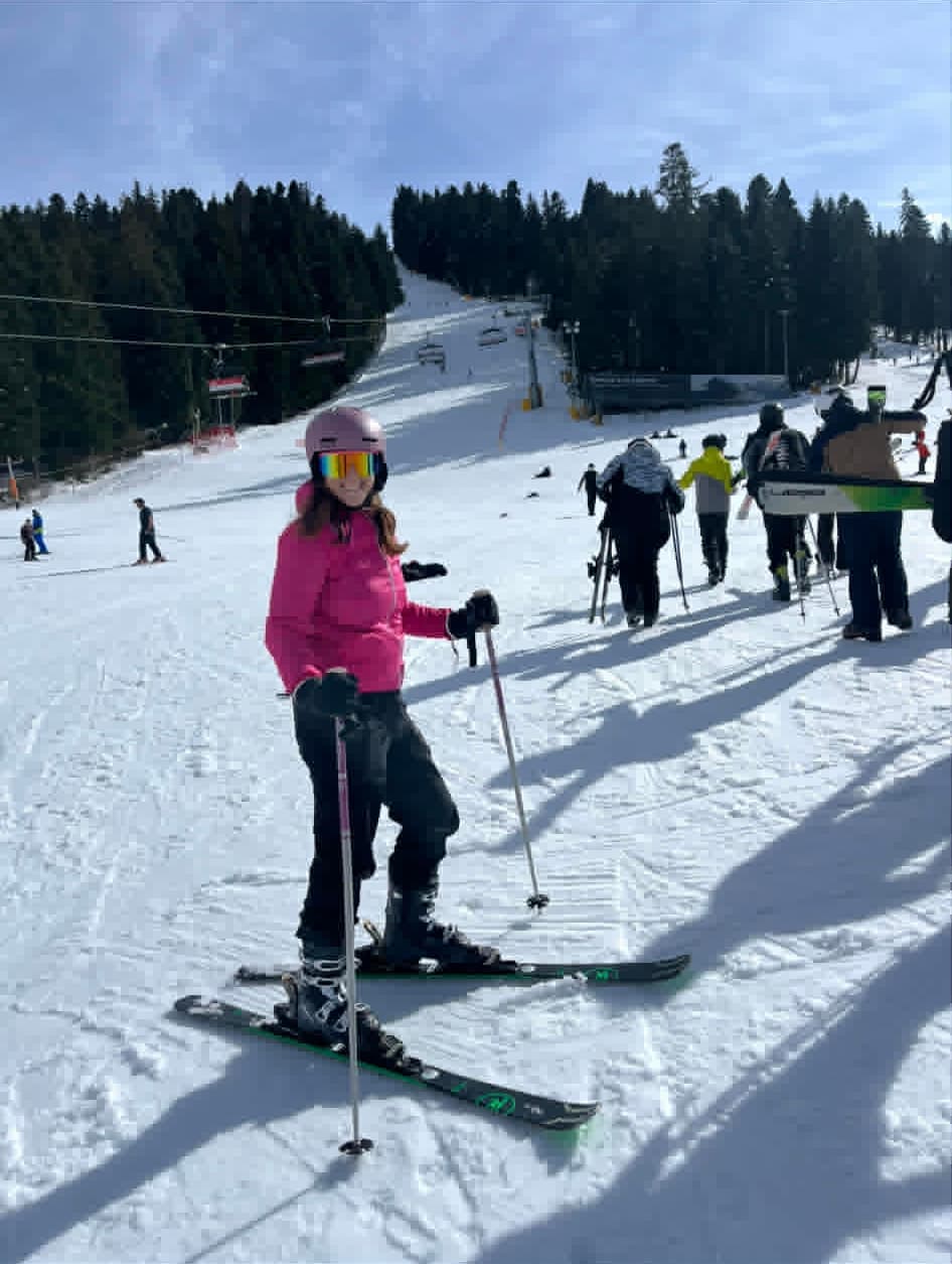 Young student relaxing after the end of a ski lesson