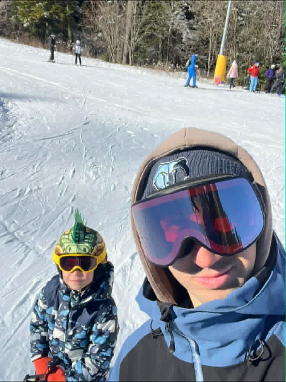 Selfie with a small child having fun with ski instructor