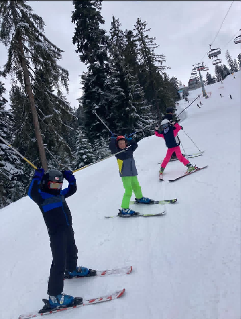 Children group enjoying ski lesson