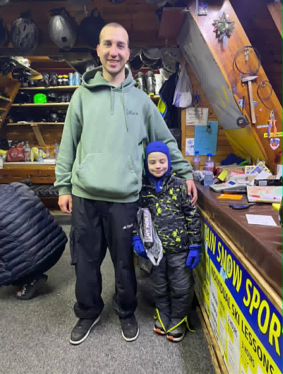 A picture of a ski instructor and a child student