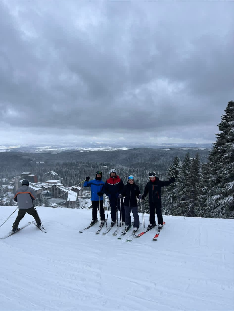 A group of adult ski students ready to go down the ski path