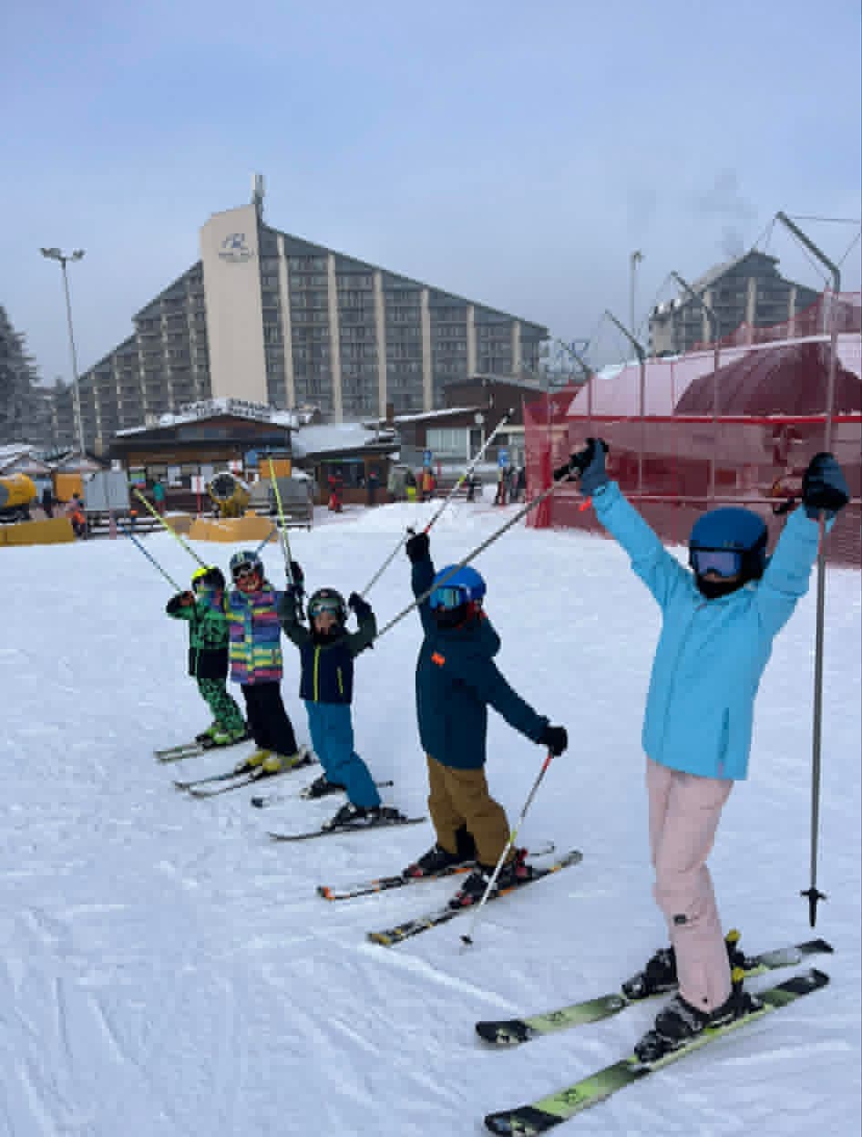 A group of skiers getting ready to hop on the 'Martinovi Baraki Express' chairlift